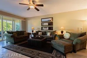 Recessed lighting, ceiling fan, and large sliding glass door with external greenspace