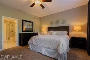 Wall-to-wall carpeting with an angled ceiling, ceiling fan, and a built-in recessed light fixture
