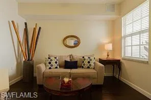 Dark wood-finish flooring with light-toned walls