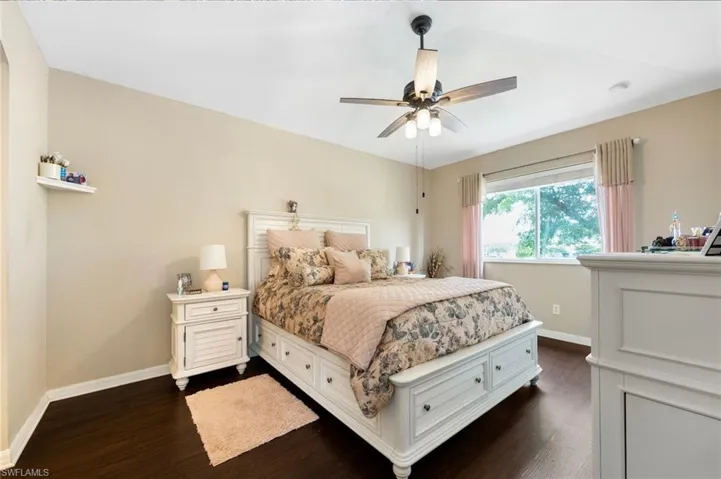 Bedroom with dark wood-style floors and a ceiling fan