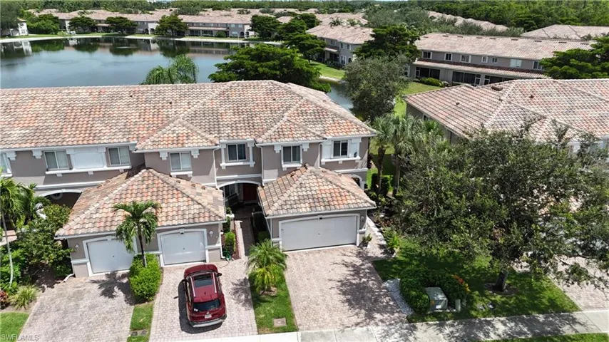 Aerial view of residential area featuring a nearby body of water