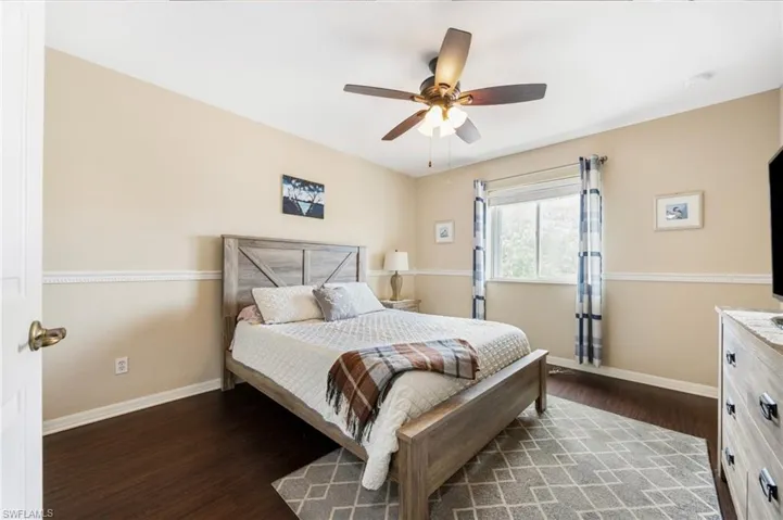 Bedroom featuring dark wood-style floors and a ceiling fan