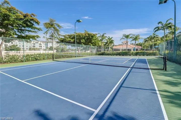 View of tennis court with community basketball court