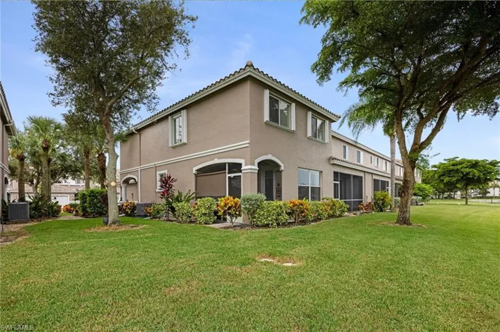 View of home's exterior featuring stucco siding, a yard, a sunroom, and a tile roof