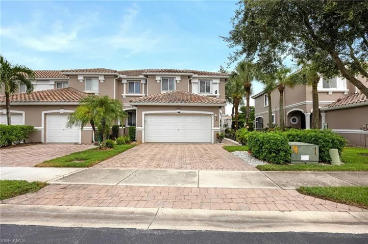 Mediterranean / spanish-style home with decorative driveway, stucco siding, and a tiled roof