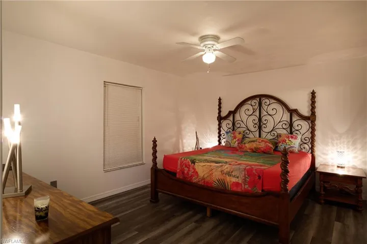 Bedroom with dark wood-style floors and ceiling fan