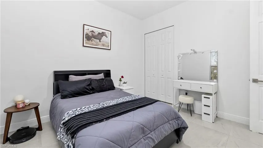 Bedroom with baseboards and a closet