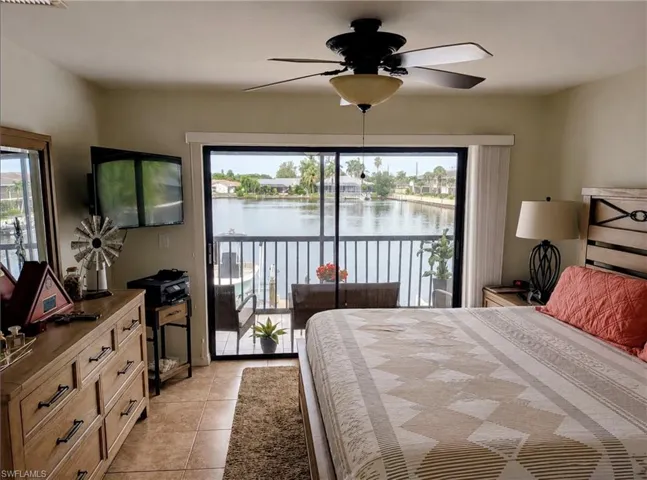 Sliding glass door leading to a private balcony with a water view
