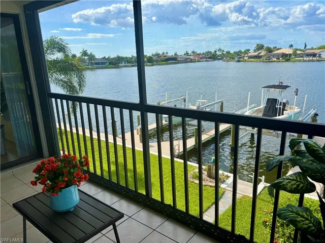 Screened balcony overlooking a wide canal waterway