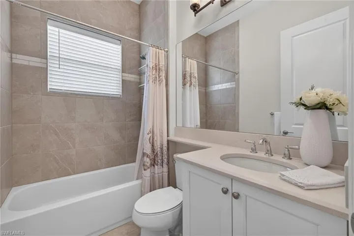 All 3 full baths feature to the ceiling tile upgrade! This one is the shared bath to the right of the foyer and adjacent to the 3rd bedroom.