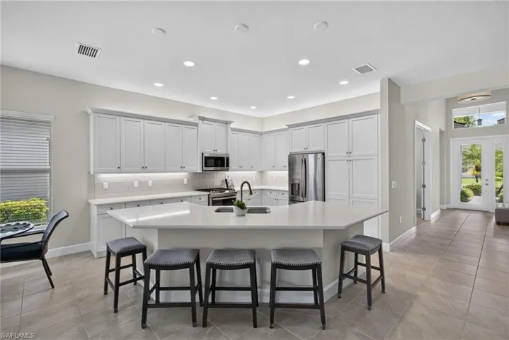 Quartz countertops, seating for 5 at bar, large pantry, and above and below cabinetry lighting are all yours to enjoy!