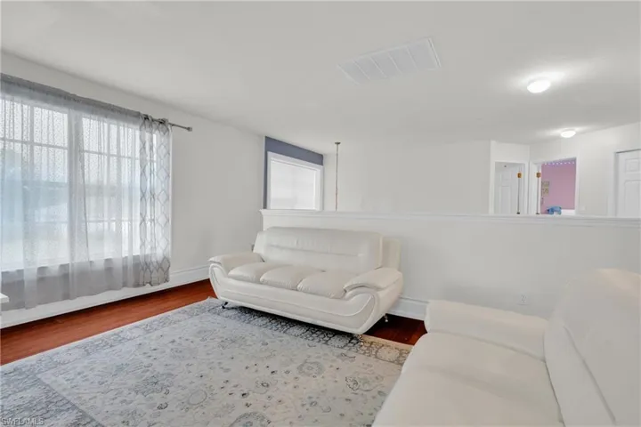 Living room featuring wood finished floors and plenty of natural light