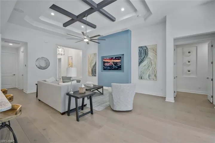 Living area featuring recessed lighting, light wood-type flooring, baseboards, and coffered ceiling