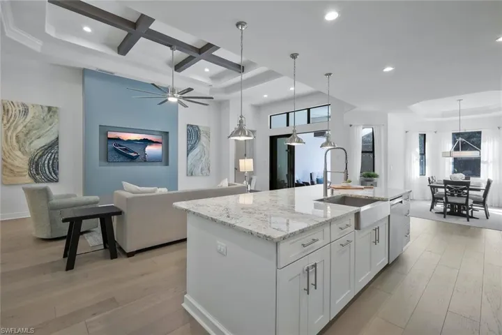 Kitchen with a sink, light wood-type flooring, and open floor plan