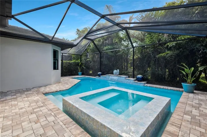 View of pool featuring a patio area and a pool with connected hot tub