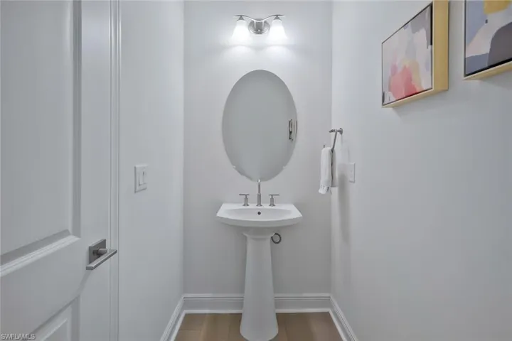 Bathroom featuring baseboards and wood finished floors