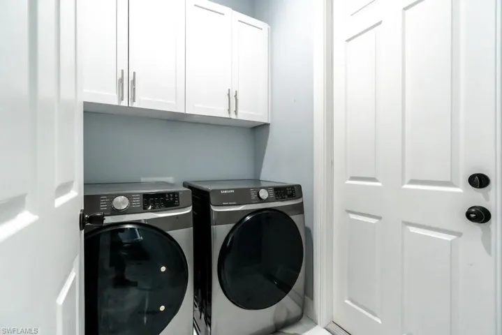 Laundry area with independent washer and dryer and cabinet space