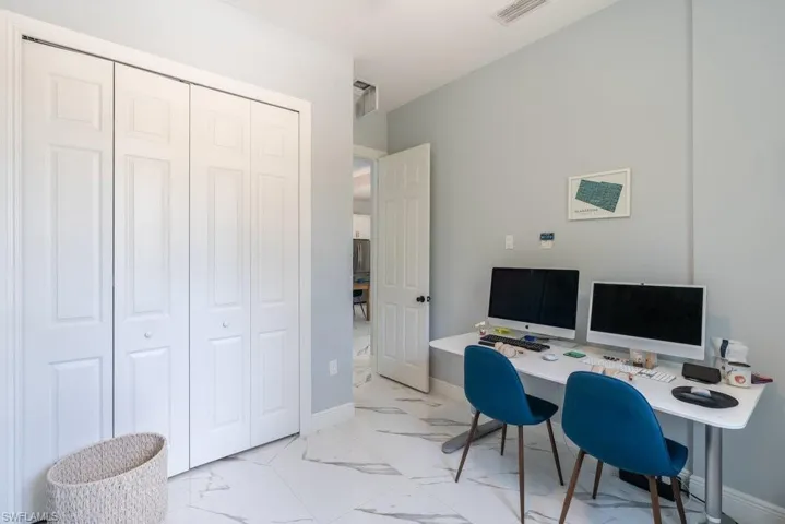 Office with light marble finish floors and baseboards