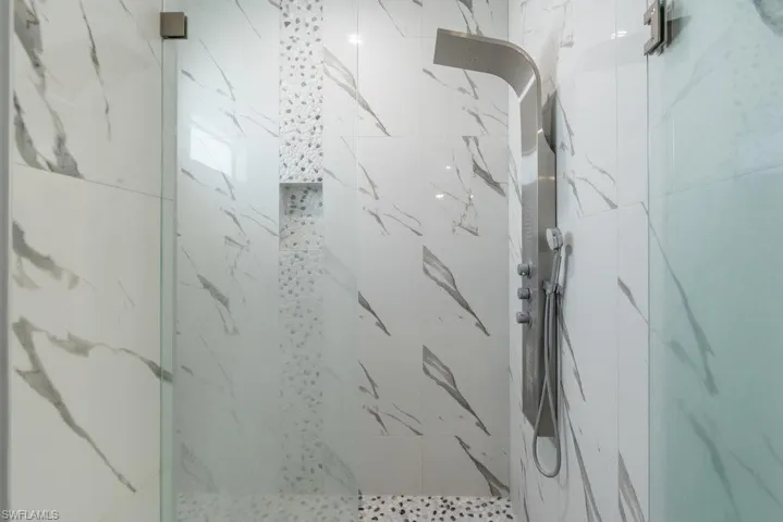 Bathroom with a marble finish shower