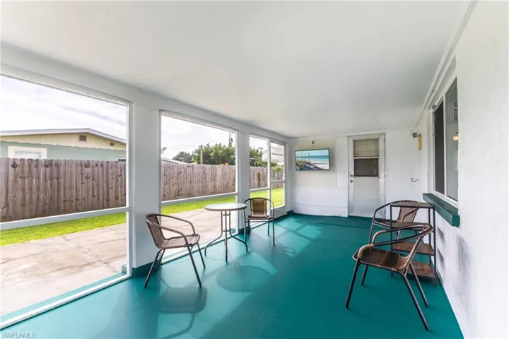 Screened porch featuring a teal floor, white walls, and clear panel enclosures