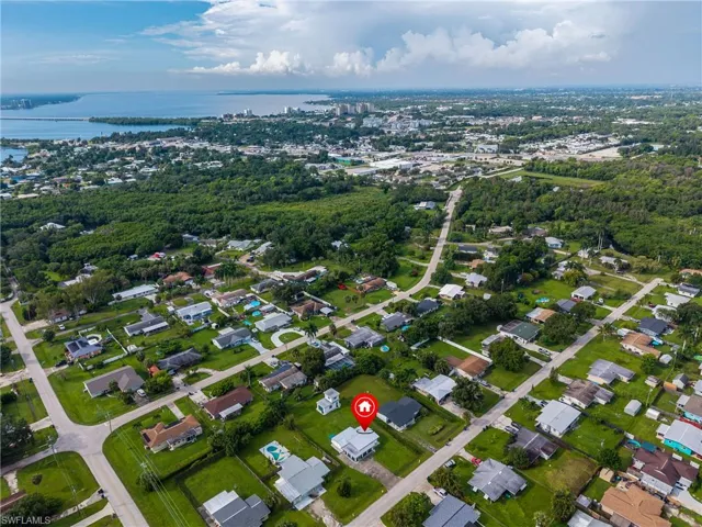 Aerial perspective of the surrounding residential area and distant waterfront