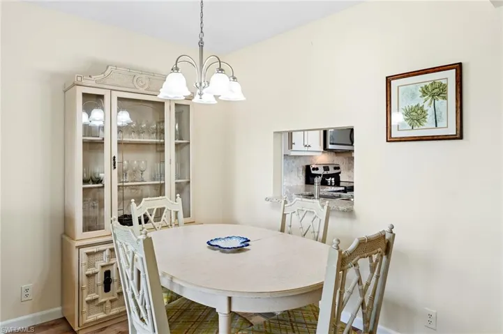 Dining area featuring a notable chandelier and vinyl flooring