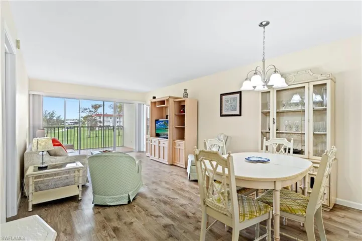 Dining space featuring an inviting chandelier and vinyl flooring