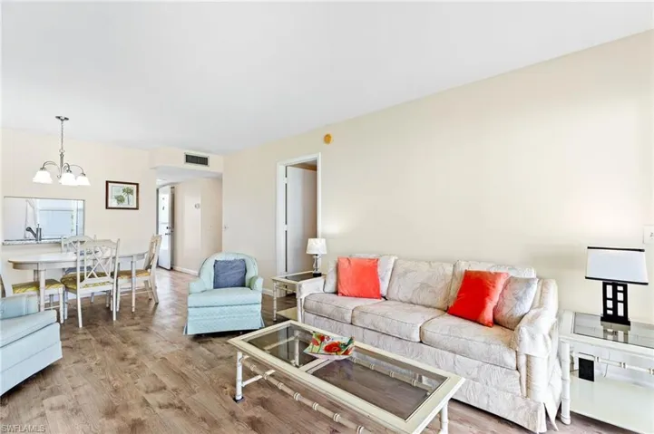Living room featuring a chandelier and vinyl  flooring