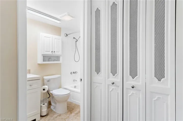 Full bathroom featuring  shower combination, vanity, and toilet