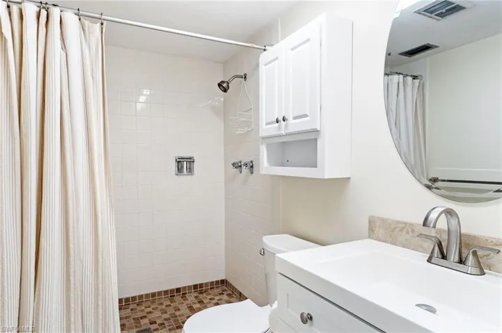 Master Bathroom with curtained shower, vanity, and toilet