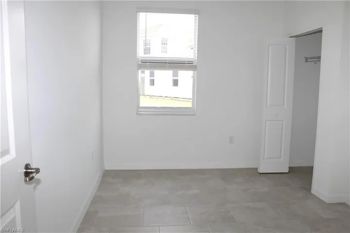 Guest room with plenty of natural light and baseboards