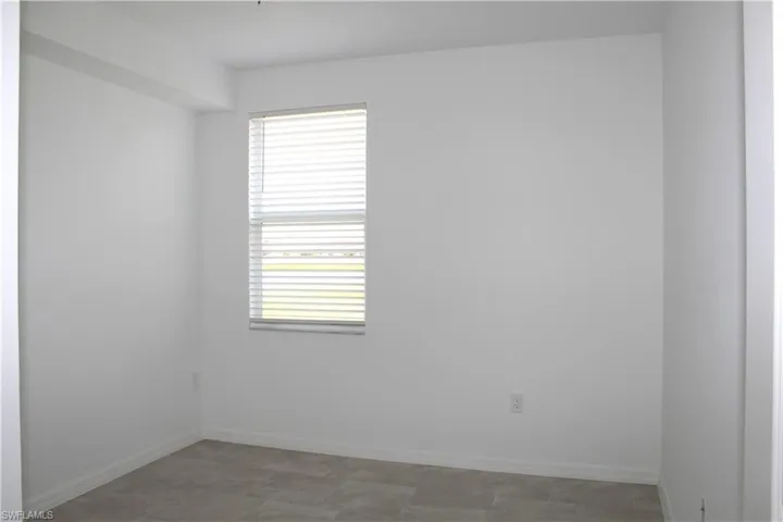 Guest room with baseboards and a healthy amount of sunlight