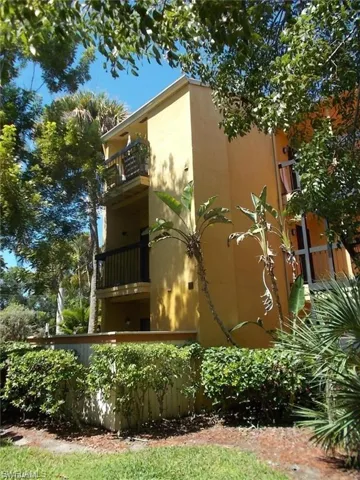 View of side of property with stucco siding and a balcony