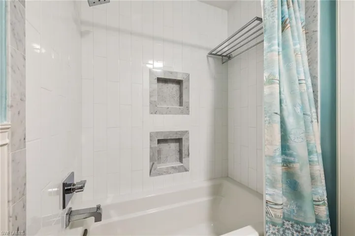 Bathroom with shower / tub combo with curtain