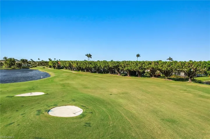 Surrounding community with a yard and a water view