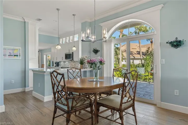 Dining area featuring a chandelier, light hardwood / wood-style floors, and crown molding