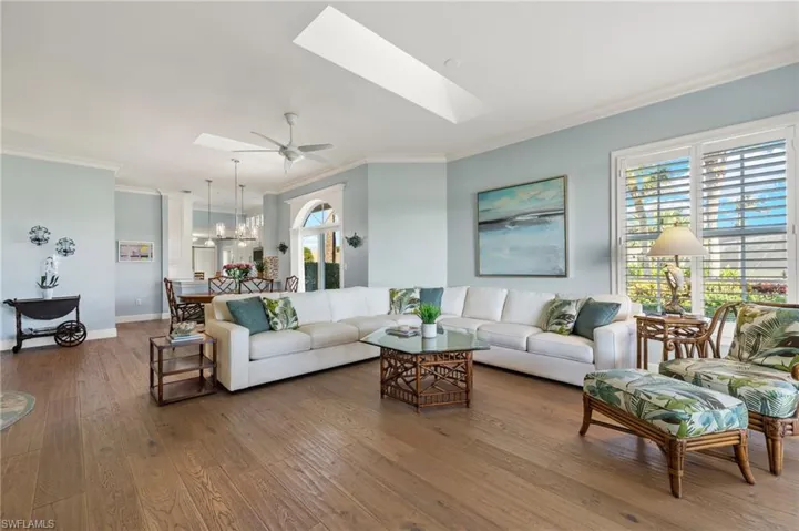 Living room featuring hardwood / wood-style flooring, plenty of natural light, and a skylight