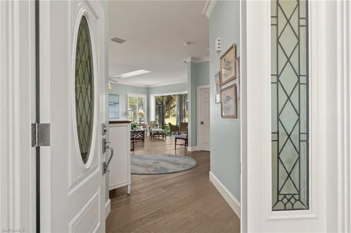 Entryway featuring crown molding and light hardwood / wood-style flooring