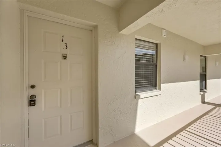 View of exterior entry featuring stucco siding