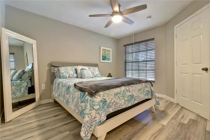 Bedroom with ceiling fan and wood-type flooring