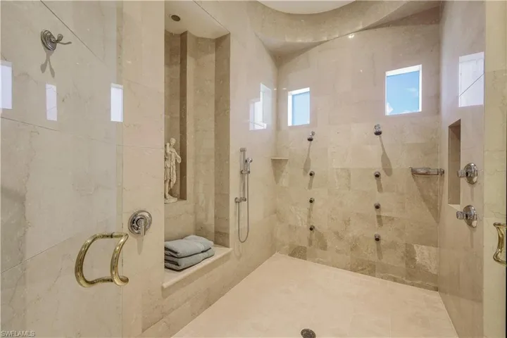 Luxurious en suite walk-in shower feels like an upscale spa.