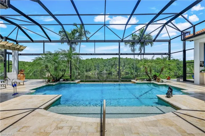 Swim day or night, this home offers COMPLETE outdoor privacy! Take in picturesque views of the lake and the preserve beyond.