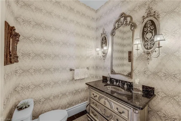 Powder room, located near formal living room and kitchen.