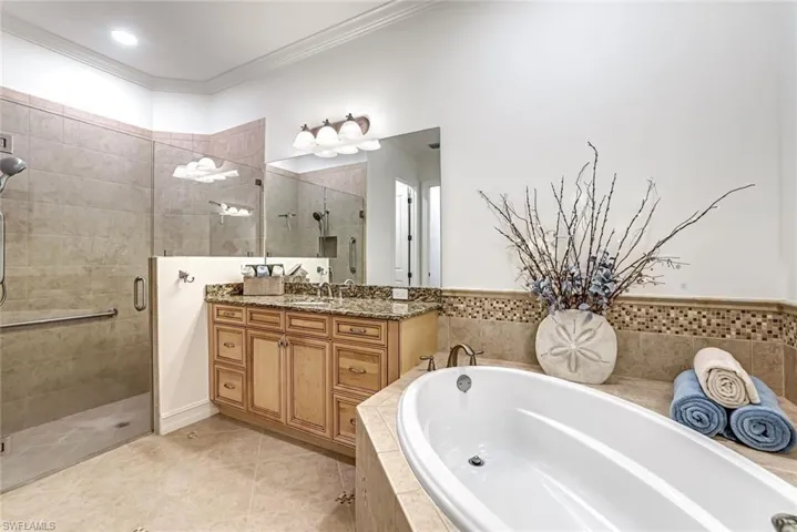 Custom shower door compliments the lovely soaking tub