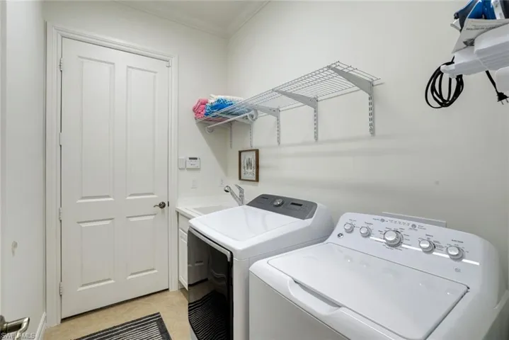 Light & bright laundry room connecting garage to the home