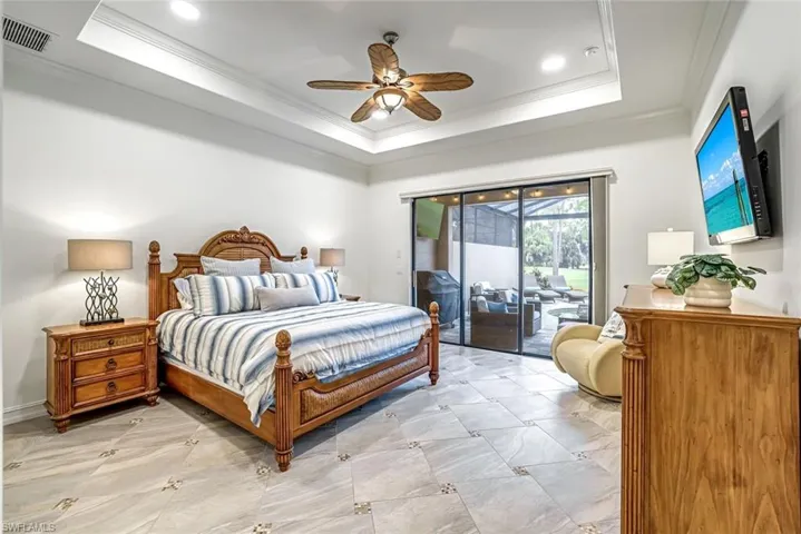 Primary bedroom with view to lanai and golf course