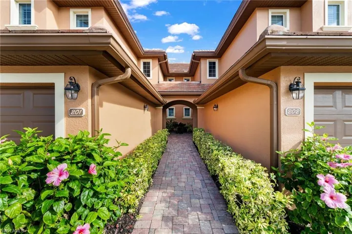 View of exterior entry featuring a garage and stucco siding