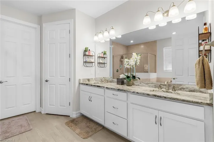 Double vanity with gray-veined countertop, dual undermount sinks, and brushed nickel fixtures