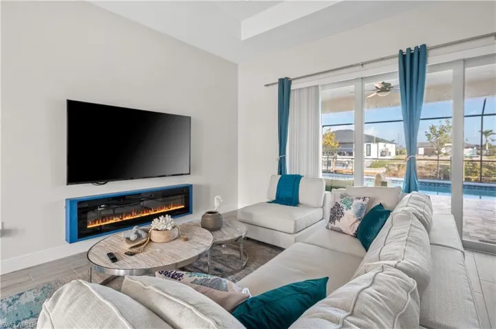 Living room with ceiling fan and a healthy amount of sunlight