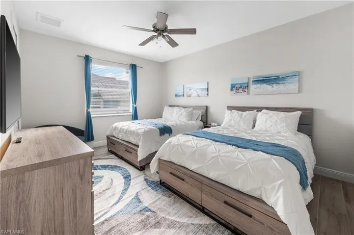 Bedroom with ceiling fan and light hardwood / wood-style floors